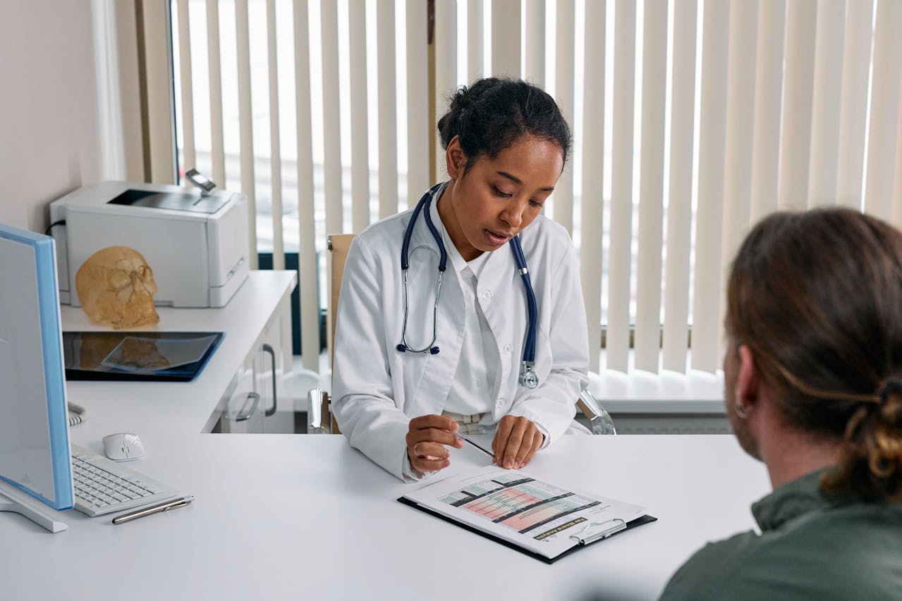 A doctor looking over a chart with a patient